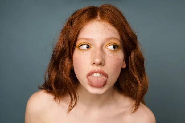 Shirtless Ginger Woman Showing Her Tongue Looking Aside Isolated Grey — Stock Photo, Image