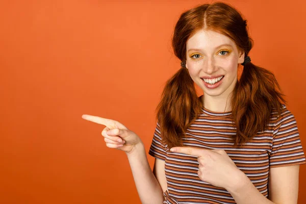 Ingwer Fröhliche Frau Mit Schwanz Lächelnd Und Finger Zur Seite — Stockfoto