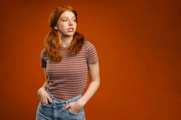 Ginger Young Woman Tails Posing Looking Aside Isolated Orange Background — Stock Photo, Image