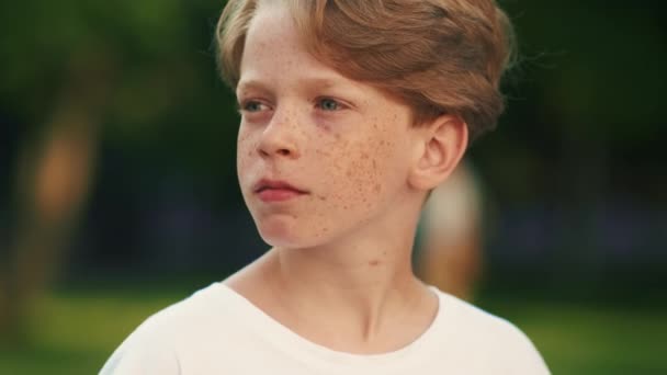 Little Boy Freckles Thinking Something While Looking Side Standing Park — Stock Video
