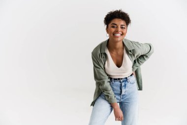 Young black woman in shirt laughing and looking at camera isolated over white background
