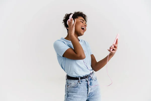 Laughing Black Woman Listening Music Headphones Cellphone Isolated White Background — Stockfoto