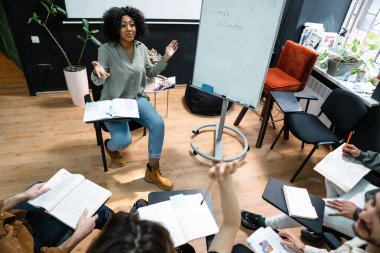 Multiethnic group of students studying together in the classroom