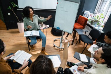 Multiethnic group of students studying together in the classroom