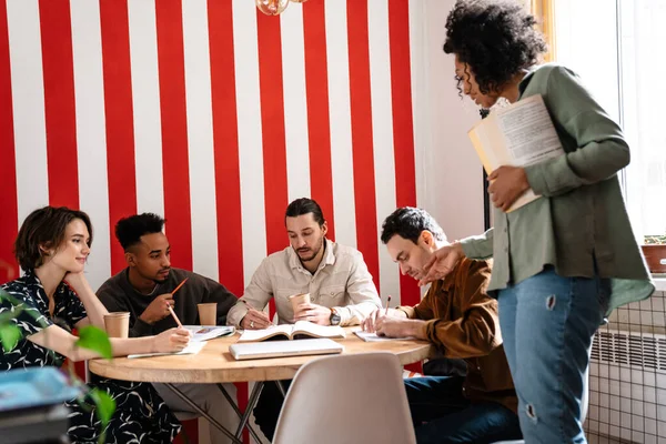 Mixed-race group shares ideas creative thoughts with multi-ethnic mates, teamwork leadership concept