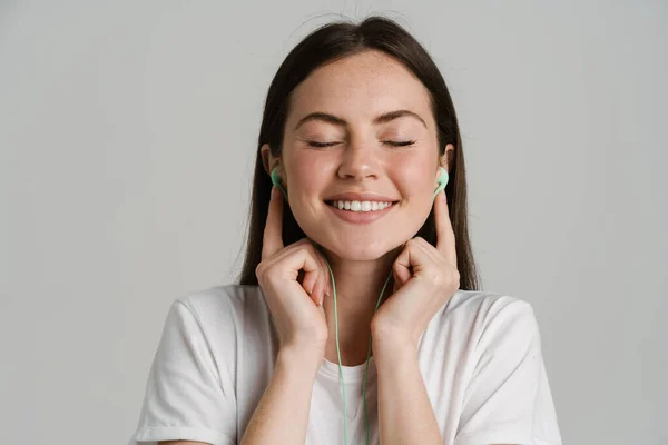 Young Brunette Woman Listening Music Earphones Isolated White Background — Stockfoto