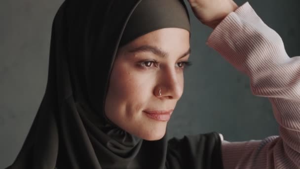 Smiling Arabian Woman Wearing National Hijab Looking Side While Correcting — 비디오