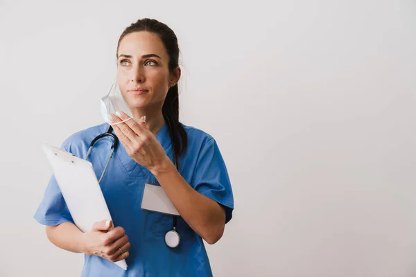 Confident Young Woman Doctor Specialist Wearing Uniform Holding Notepad Isolated — Stock Photo, Image