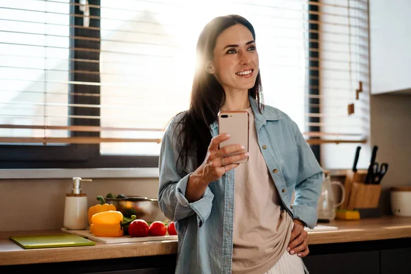 Sonriendo Atractiva Mujer Joven Mensajes Texto Teléfono Móvil Cocina — Foto de Stock