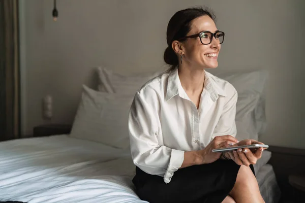 Sonriente Mediana Edad Morena Blanca Empresaria Sentada Cama Una Habitación —  Fotos de Stock