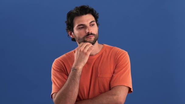 Serious Brunette Man Pondering Standing Isolated Blue Background Studio — Stock Video