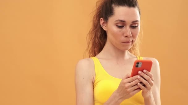 Uma Mulher Pensante Vestindo Terno Esporte Amarelo Usando Seu Celular — Vídeo de Stock