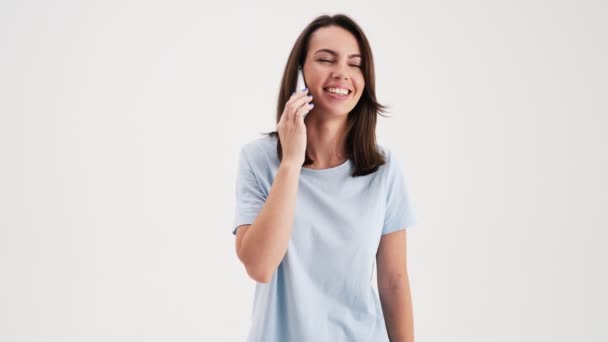 Happy Woman Wearing Basic Shirt Talking Her Mobile Standing Studio — Stock video