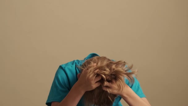 Nervous Little Boy Grabbing His Head Isolated Beige Background Studio — Stock Video