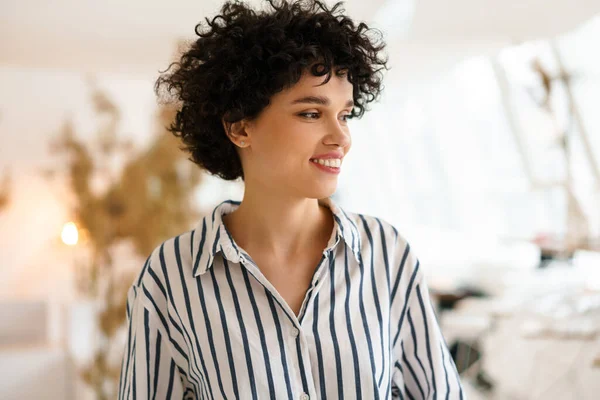 Beautiful Curly Happy Woman Smiling Looking Aside Indoors — Stock Photo, Image