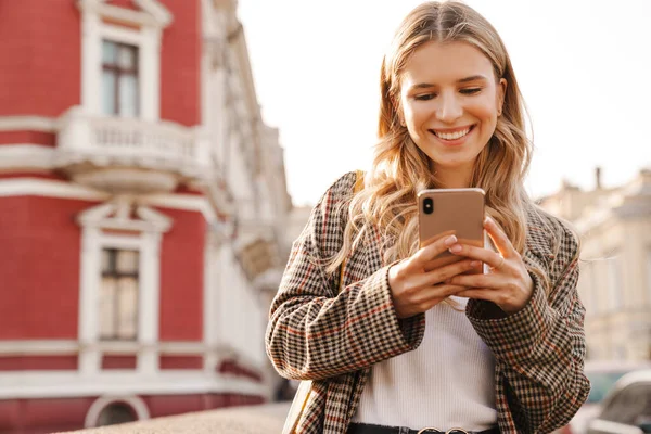 Sorrindo Jovem Loira Usando Telefone Celular Andando Uma Rua Cidade — Fotografia de Stock