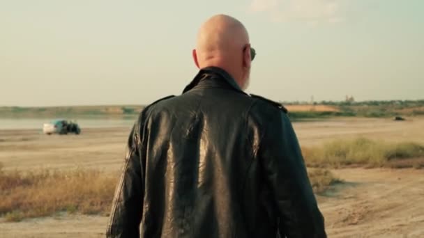 Bald European Biker Man Beard Wearing Leather Jacket Walking Lake — Stock Video