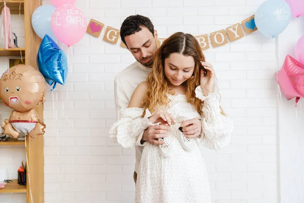 Young Happy Couple Posing Baby Shoes Gender Reveal Party Indoors — Stock Photo, Image