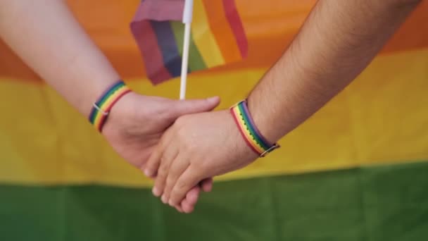 Gökkuşağı Bilezikleriyle Ele Tutuşan Bir Adamın Kırpılmış Görüntüsü Lgbt Hakları — Stok video