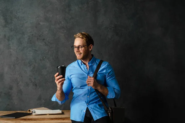 Smiling Man Blue Shirt Glasses Holding Cup His Hand While — Stock Photo, Image