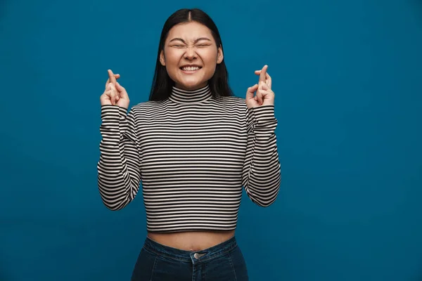 행운을 손가락을 교차하여 배경에 고립된 아시아 소녀의 — 스톡 사진