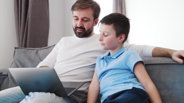 Father Talking His Son Looking Laptop Sitting Sofa Home — Stock Video