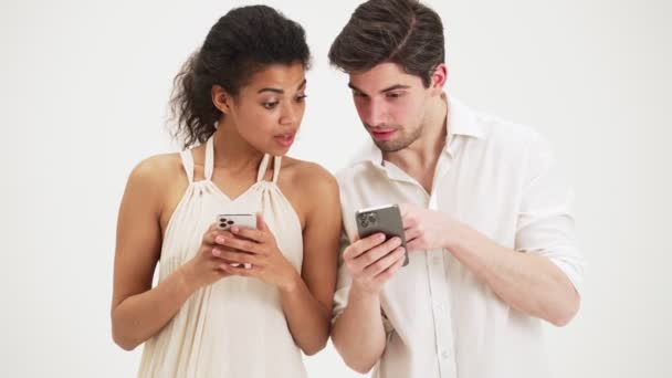 Homem Uma Mulher Usando Celulares Discutindo Algo Isolado Sobre Fundo — Vídeo de Stock