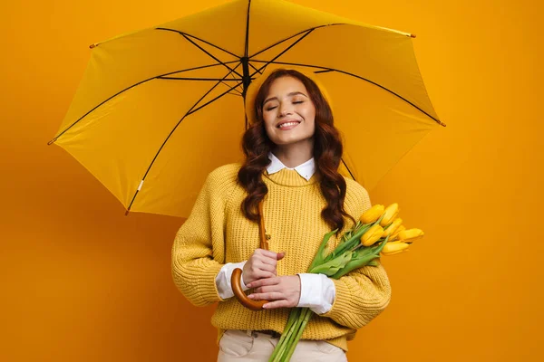 Sonriente Joven Mujer Pelirroja Sosteniendo Tulipanes Pie Bajo Paraguas Sobre — Foto de Stock