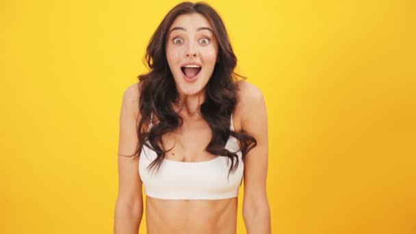 Happy Shocked Brunette Woman Rejoicing Standing Isolated Yellow Background Studio — Stock Video