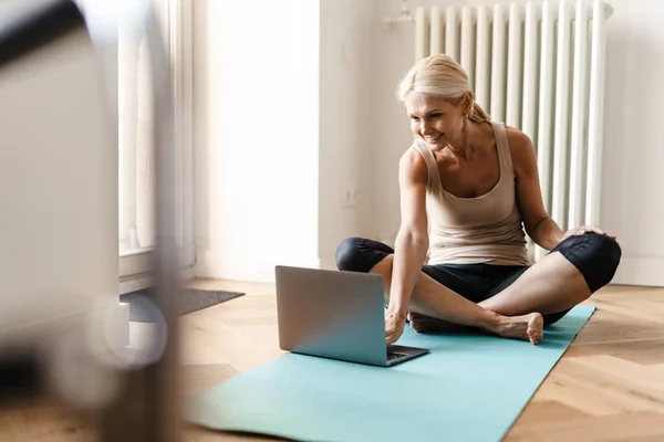 Blond Mogen Kvinna Som Använder Laptop Yogautövandet Hemma — Stockfoto
