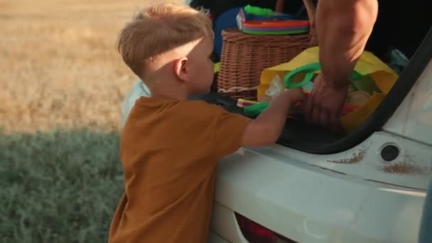 Close View Father Son Take Things Out Car Trunk — Stock Video