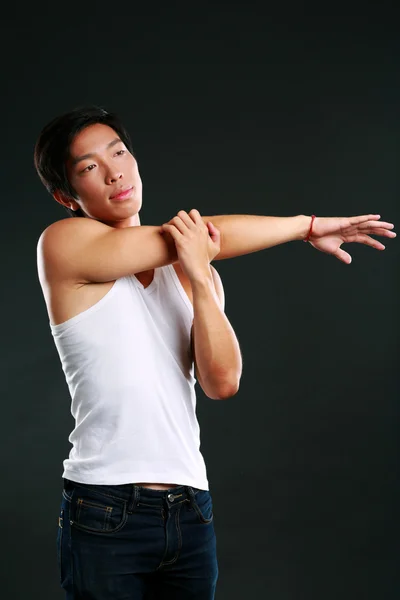 Handsome fit asian man isolated on black background — Stock Photo, Image