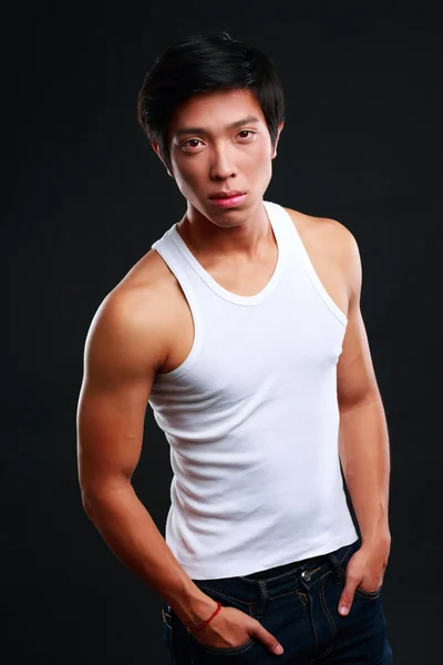 Handsome fit asian man isolated on black background — Stock Photo, Image