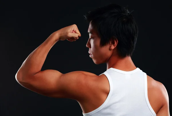 Handsome fit asian man isolated on black background — Stock Photo, Image