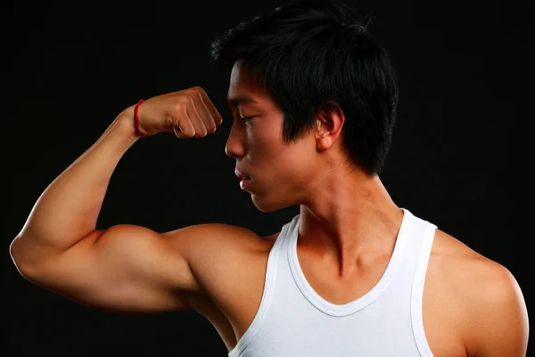 Handsome fit asian man isolated on black background — Stock Photo, Image