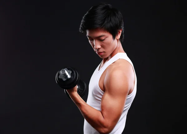 Handsome fit asian man isolated on black background — Stock Photo, Image