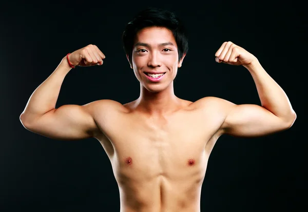 Handsome fit asian man isolated on black background — Stock Photo, Image