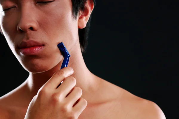 Handsome asian man isolated on black background — Stock Photo, Image