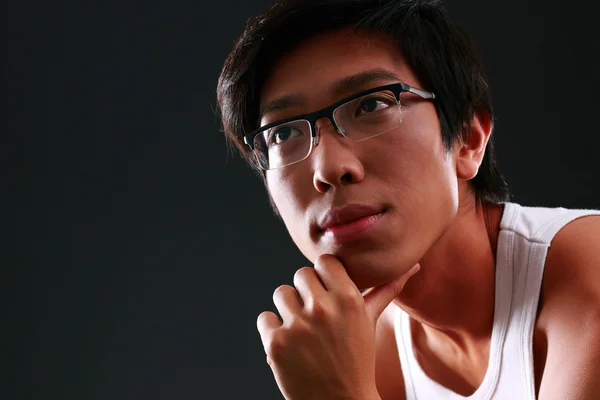 Handsome asian man over black background — Stock Photo, Image