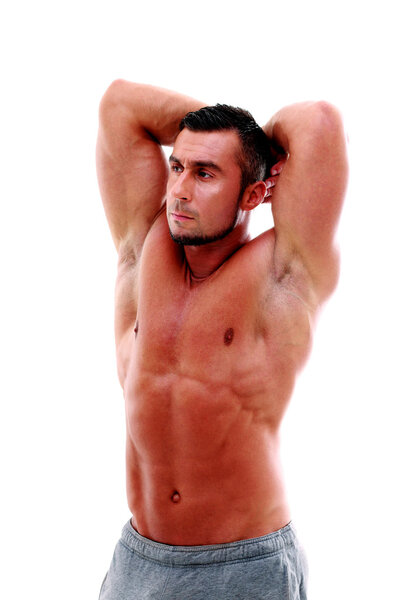 Handsome muscular sportsman standing over white background