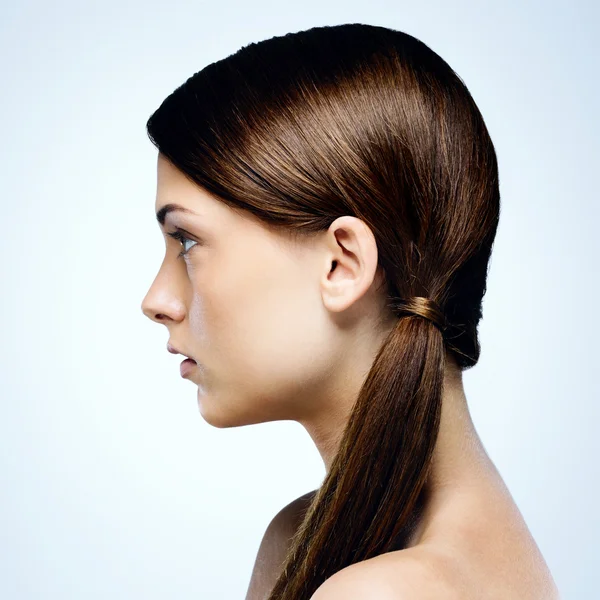 Young beautiful woman isolated on blue background — Stock Photo, Image