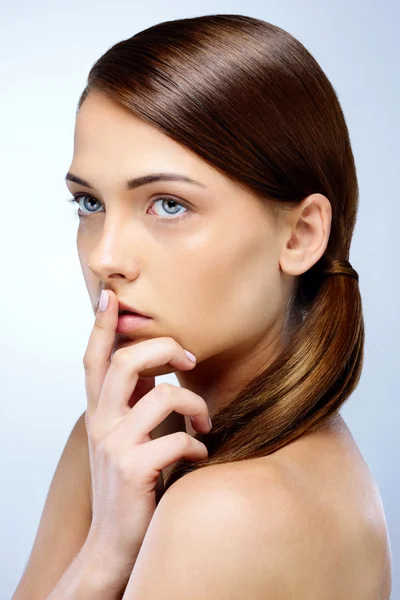 Young beautiful woman isolated on blue background — Stock Photo, Image