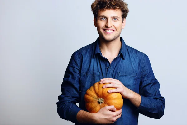 Handsome man with curly hair on blue backgorund — Stock Photo, Image