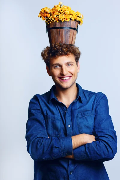 Handsome man with curly hair on blue backgorund — Stock Photo, Image