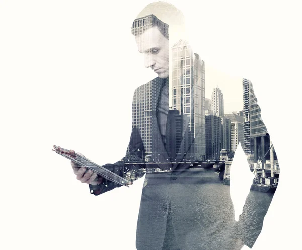 Double exposure of a businessman and a city using a tablet — Stock Photo, Image