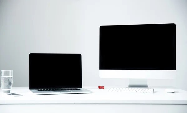 Laptop and PC on the workplace in office — Stock Photo, Image