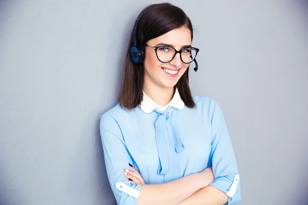 Happy businesswoman with headset and arms folded — Stock Photo, Image