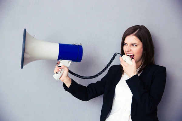 Beautiful young businesswoman with megaphone — Stock Photo, Image