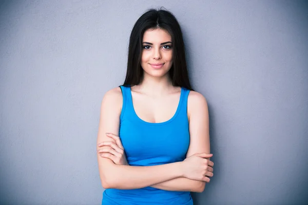 Portrait of a happy young woman with arms folded — Stock Photo, Image