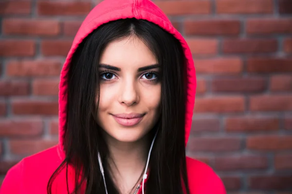 Portrait of a sporty cute woman in headphones — Stock Photo, Image